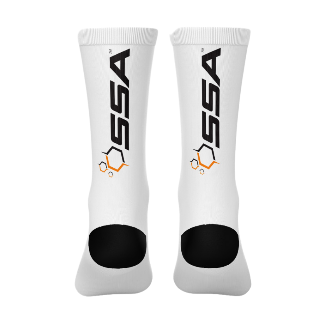 A pair of white SSA crew cut socks with orange and black branding on the side.